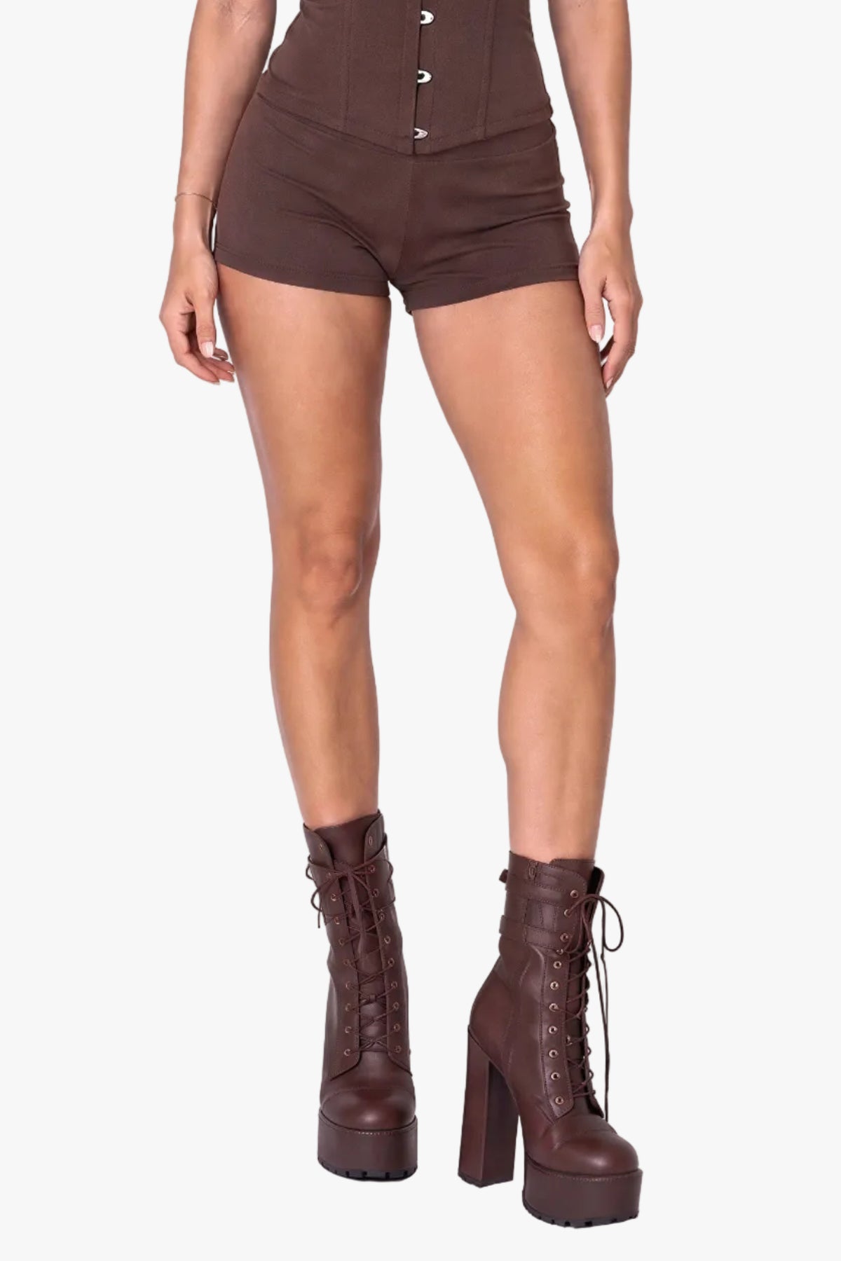 A woman modeling a delivery driver (UPS inspired) brown strapless corset with orange trim and a matching brown baseball cap, photographed against a plain light background.