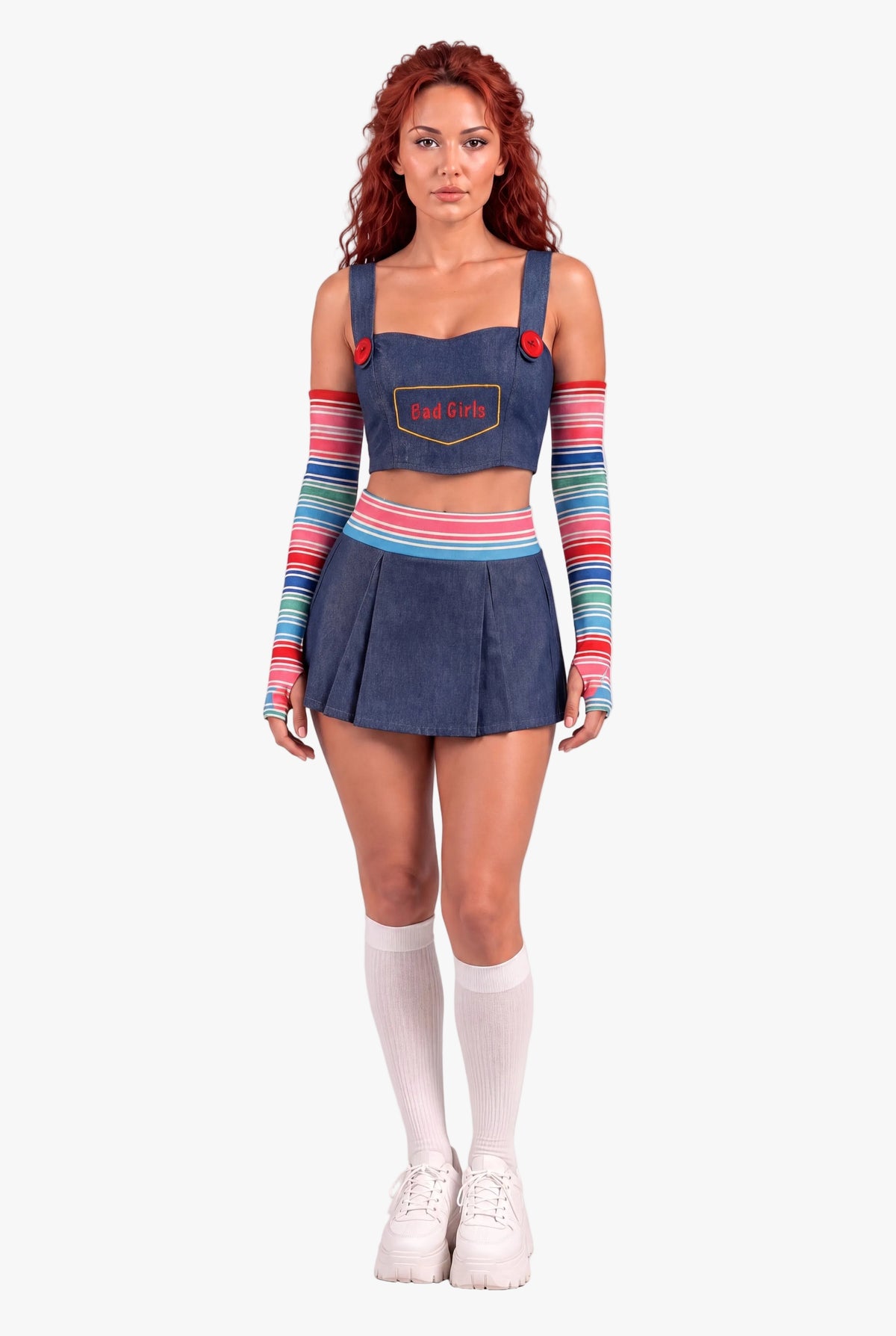 A model wearing a denim Chucky-inspired costume set featuring a crop top with a 'bad girls' patch, matching pleated mini skirt, and colorful striped arm warmers and socks, standing against a light gray studio background.