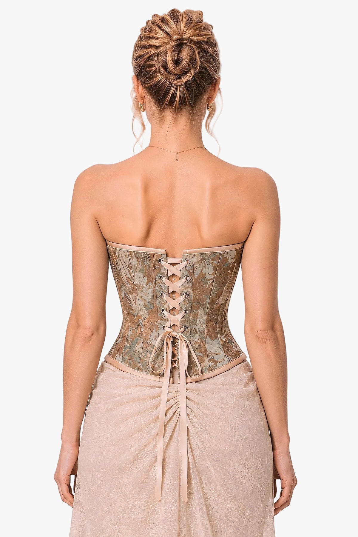 A woman shown from the back wearing a strapless corset with a floral brocade pattern in beige, taupe, and muted green, paired with a matching gathered skirt, against a light gray studio background.