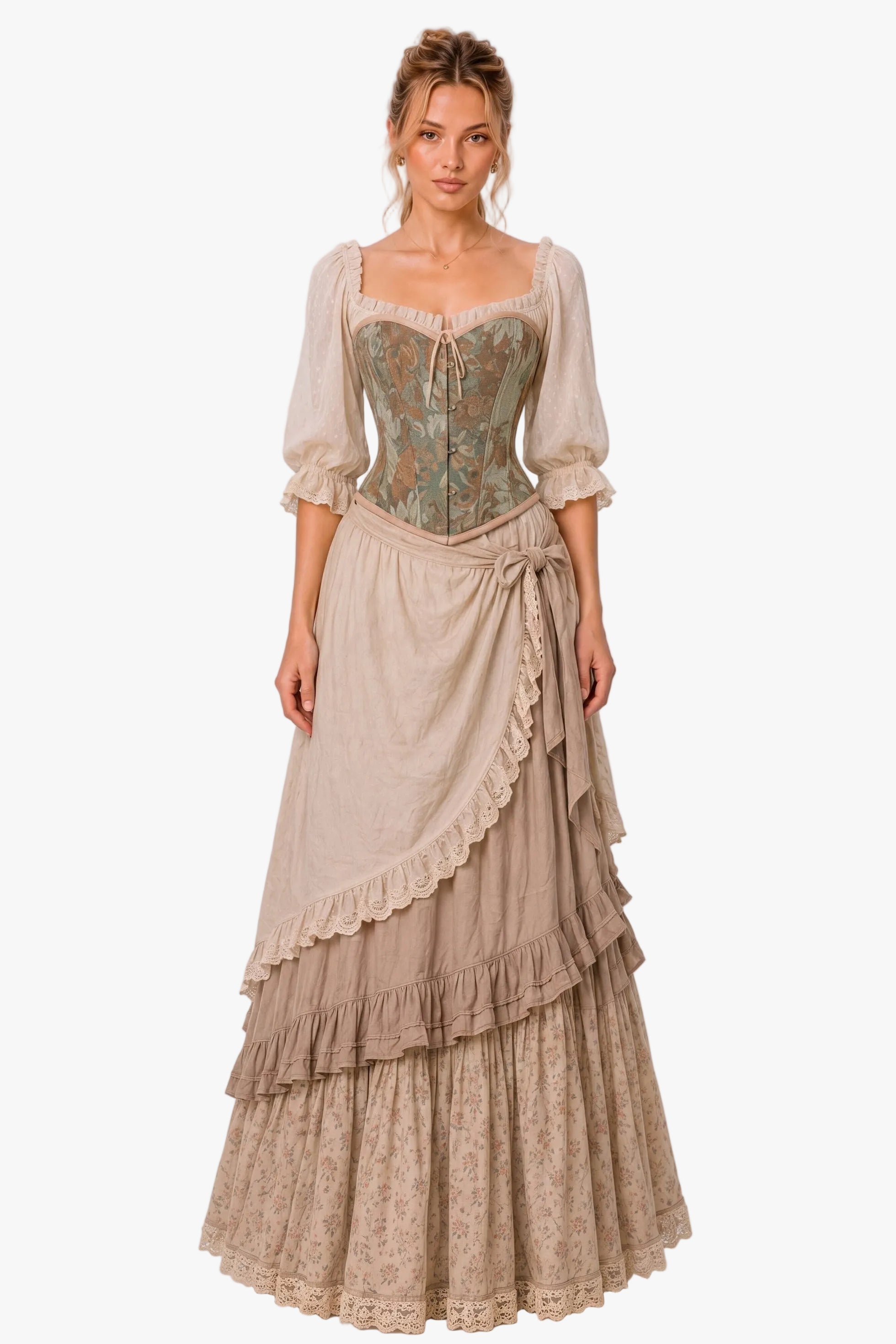 A woman modeling a long Victorian-style dress with a beige tiered skirt, lace trim, and a fitted bodice featuring green and gold floral embroidery, set against a plain light gray studio background.