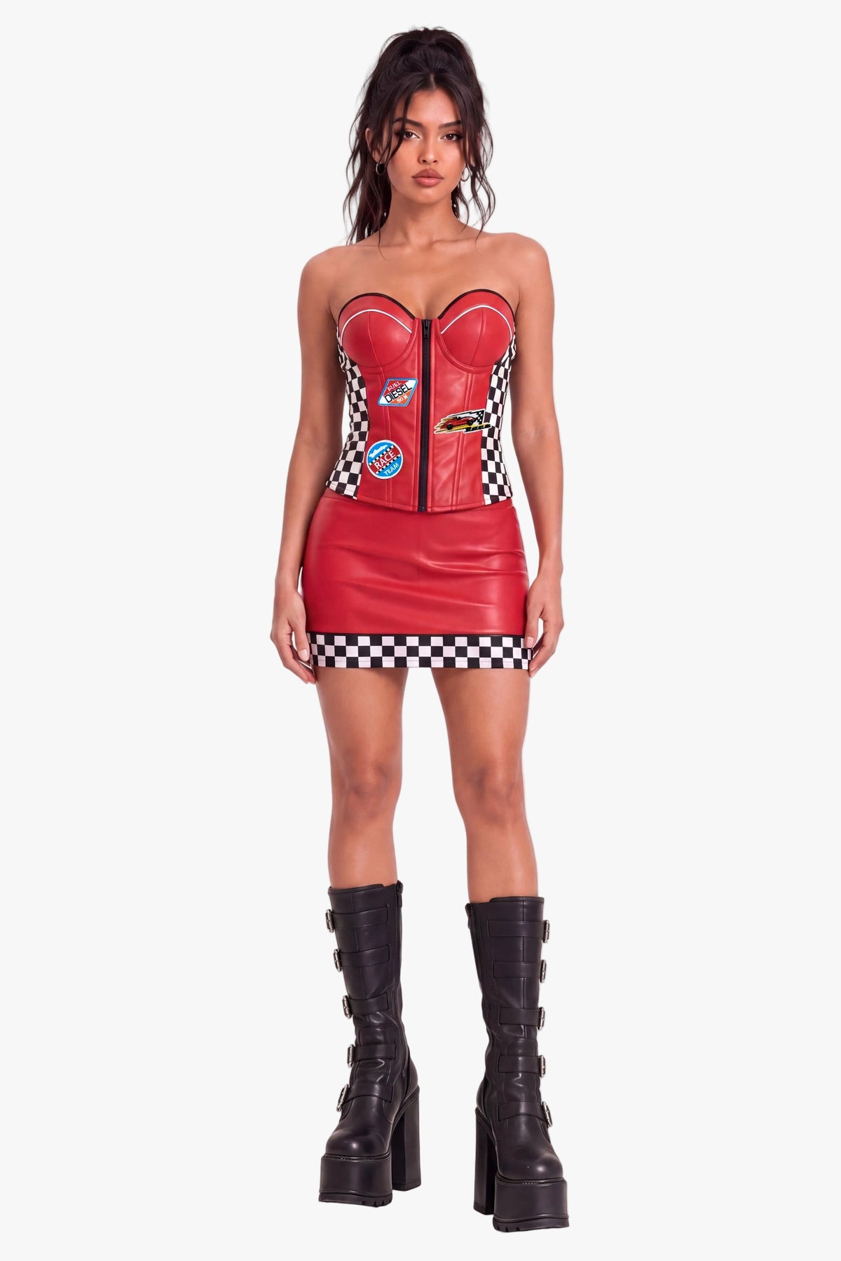 A model wearing a red faux leather racing-themed sweetheart corset-style top, black and white checkered side panels, and racing patch details, set against a plain white studio background.