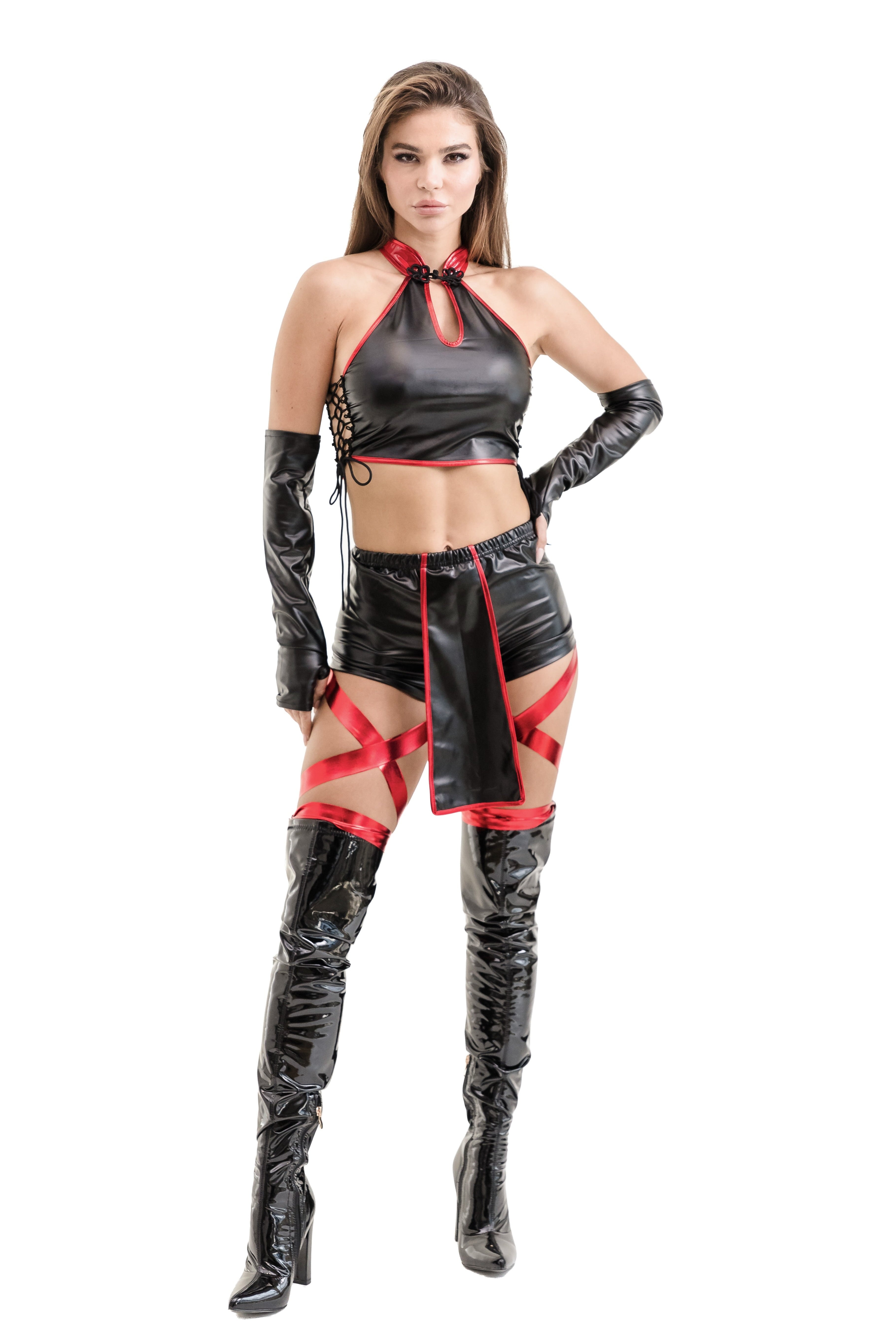 Woman wearing a black and red ninja outfit with gloves on a white background