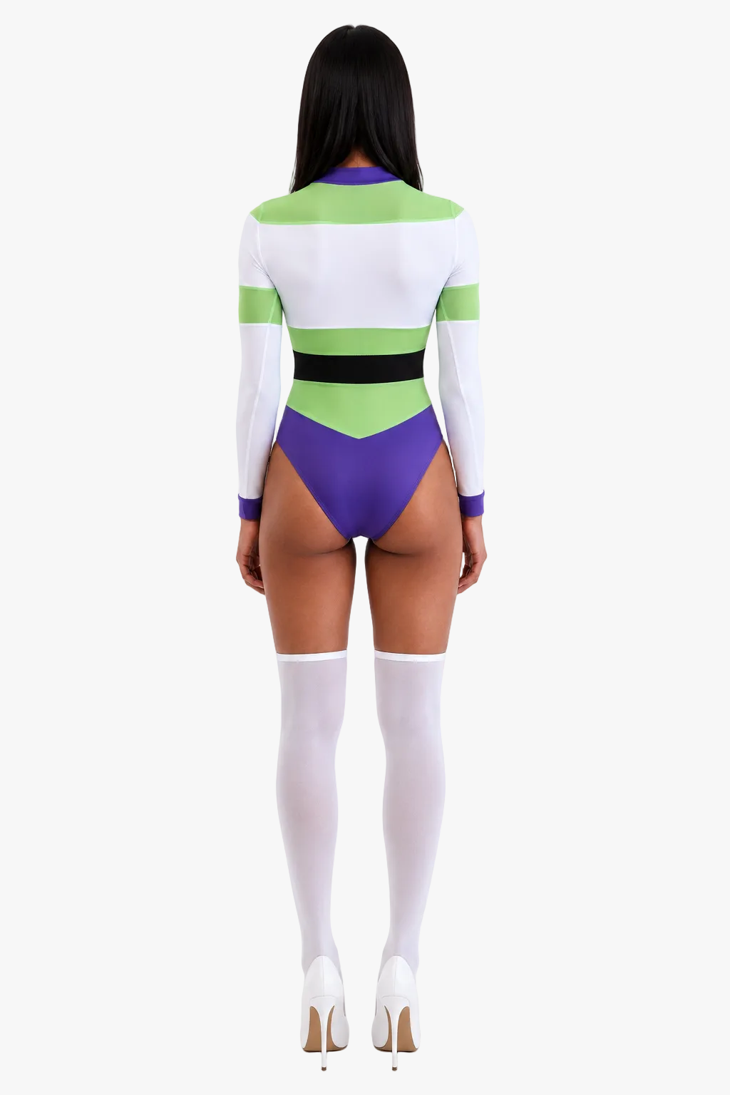 A woman shown from the back wearing a color-blocked bodysuit with long sleeves, white and green horizontal blocks, a black waistband, and purple side panels, paired with white thigh-high socks and white heels on a light gray studio background.