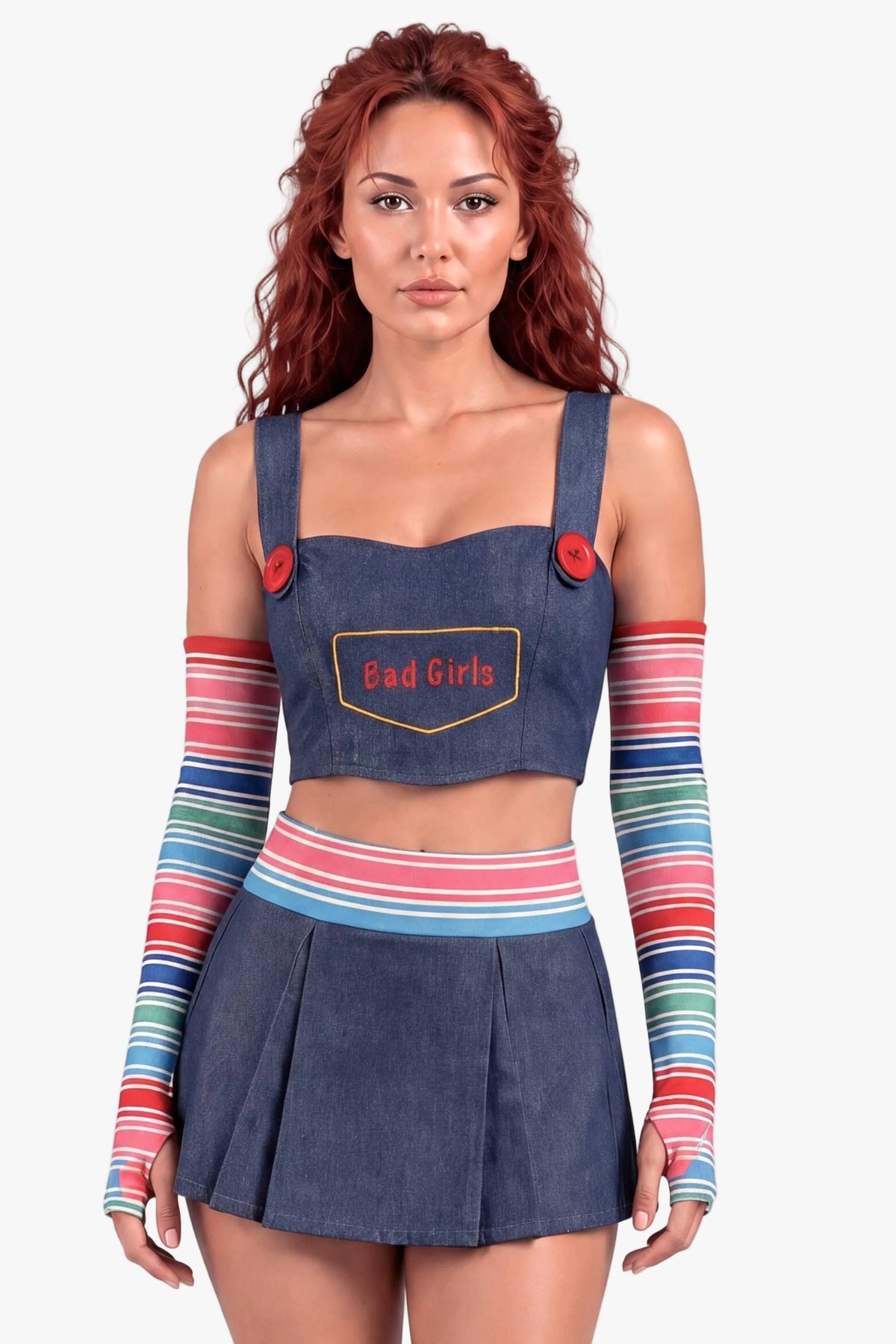 A model wearing a denim Chucky-inspired costume set featuring a crop top with 'Bad Girls' text, a matching pleated mini skirt, and colorful striped arm warmers, against a plain light gray background.