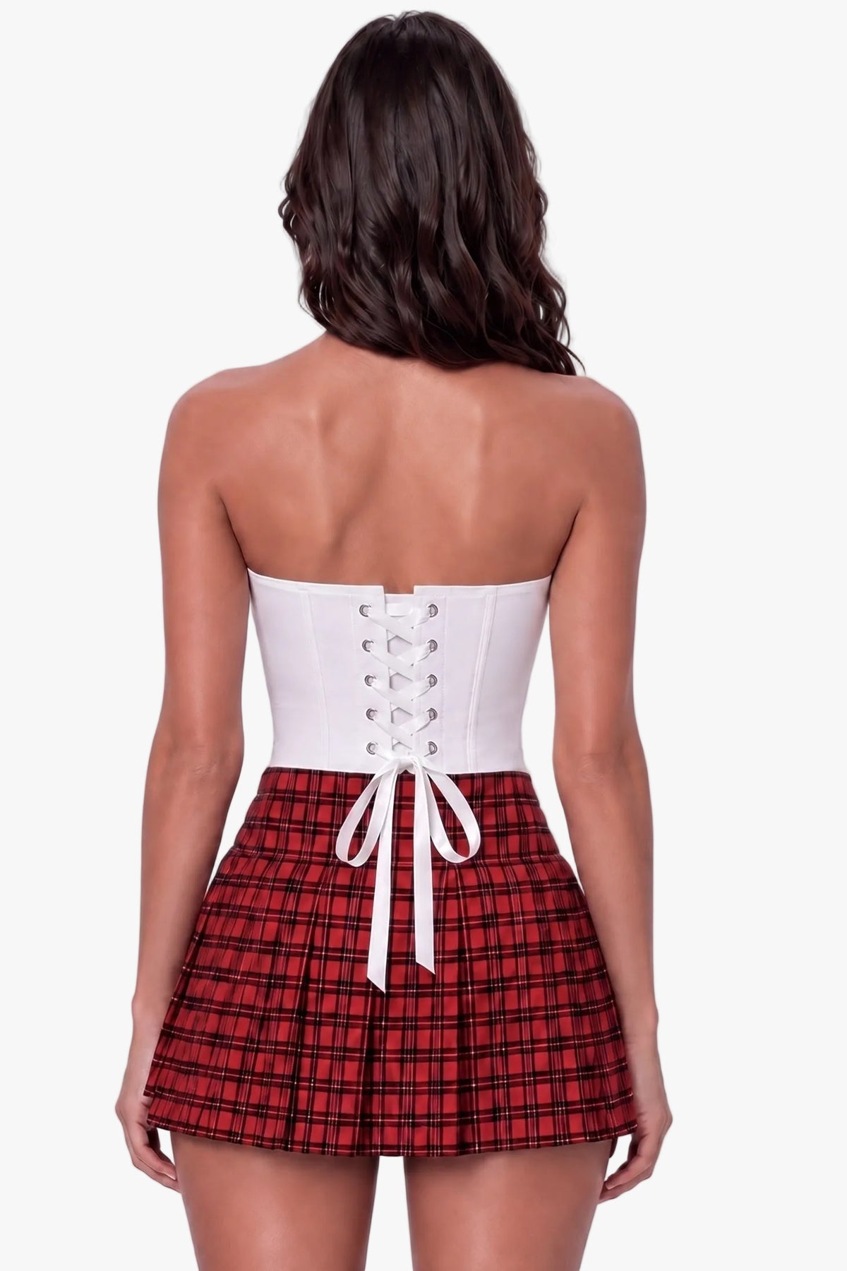 A woman shown from the back wearing a strapless corset-style top with a white lace-up back and a red-and-black plaid pleated skirt, against a light gray studio background.