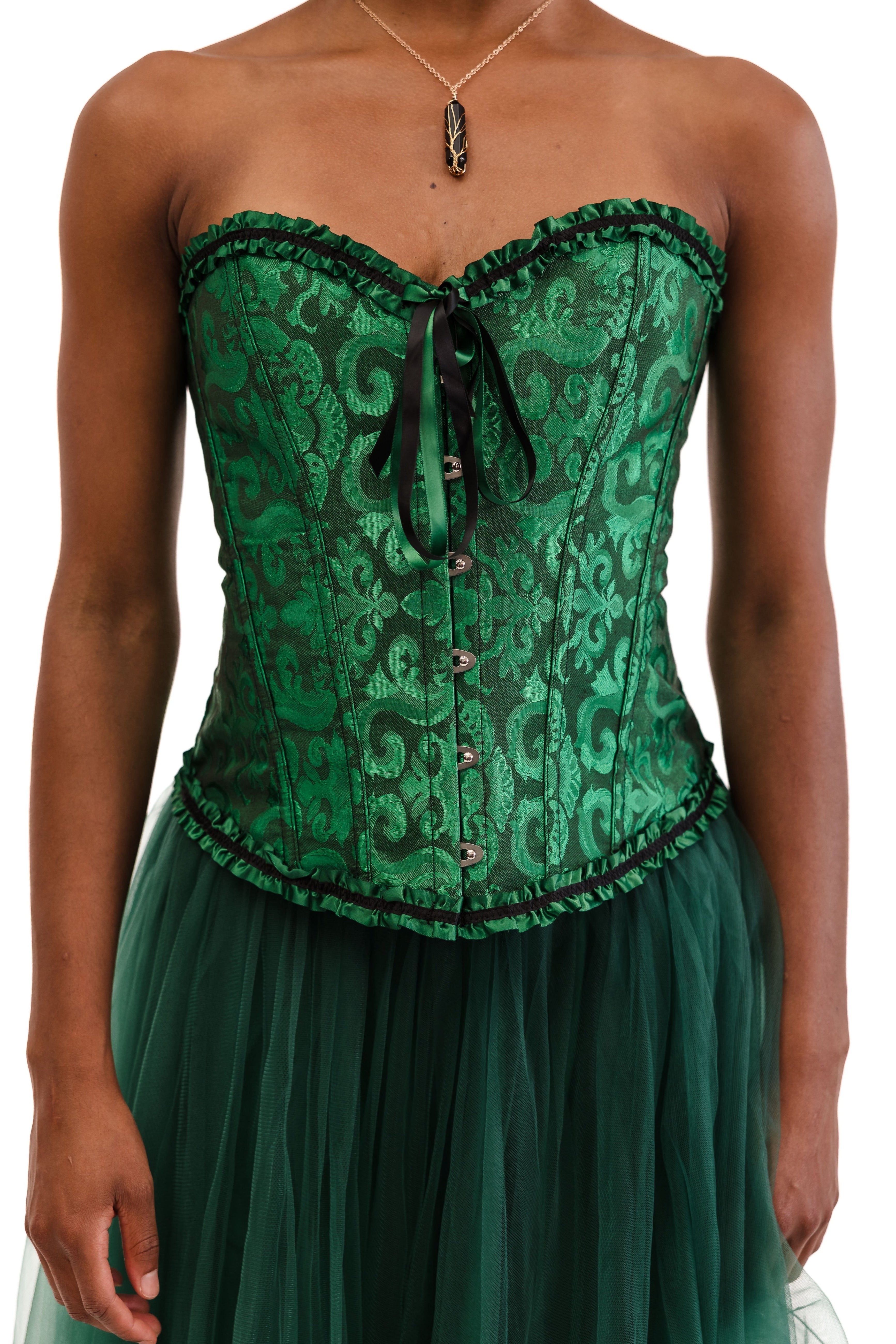 Green lace corset with a matching skirt on a white background