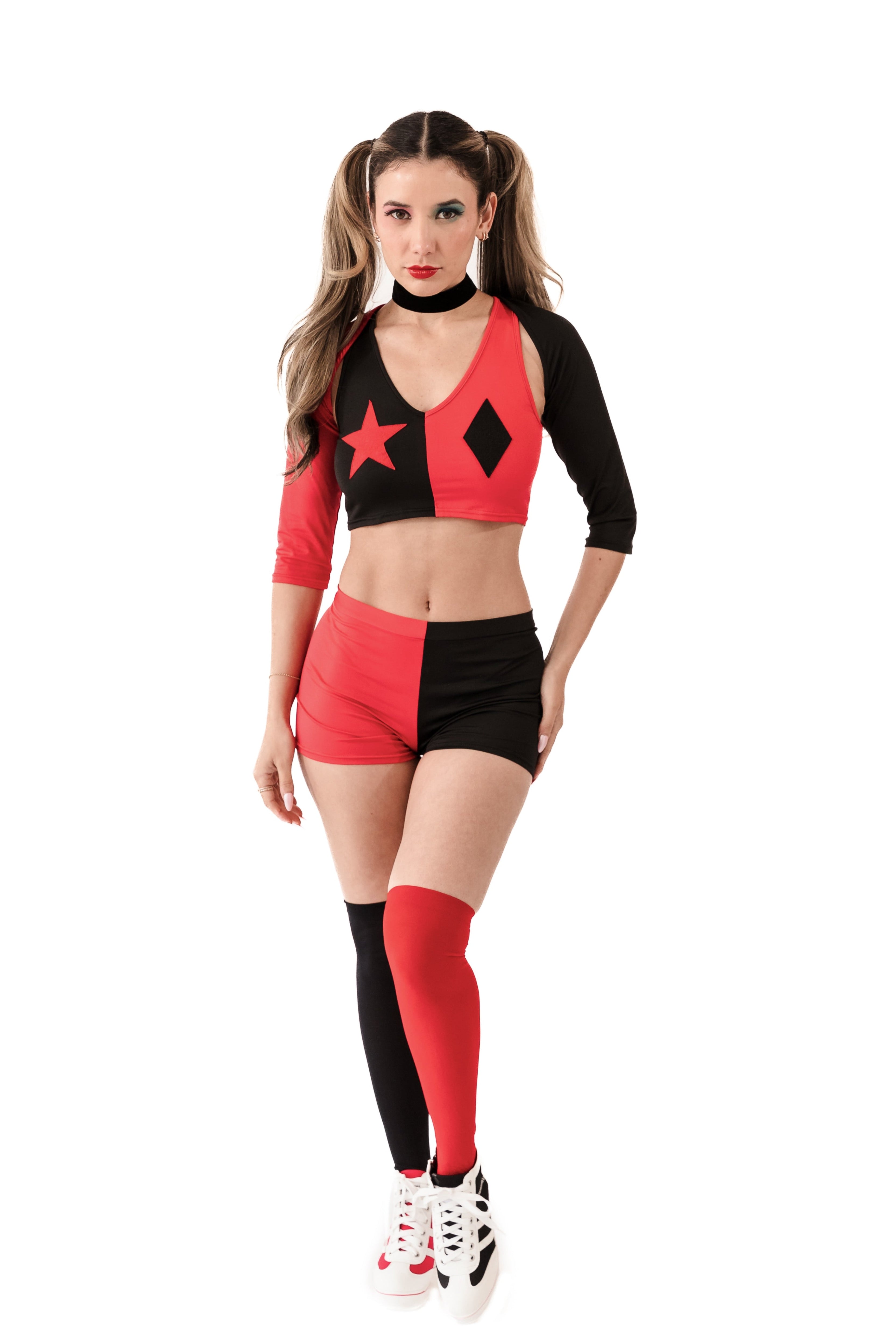 Model in red and black jester-inspired costume with pigtails and edgy details