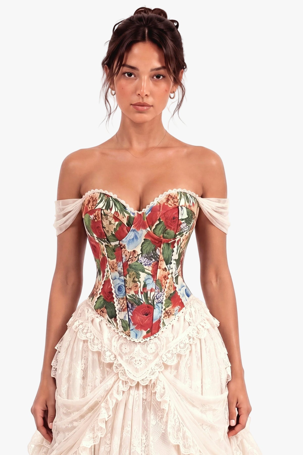 A woman modeling an off-the-shoulder corset dress with a colorful floral-patterned corset bodice and a cream ruffled skirt, set against a plain light background.