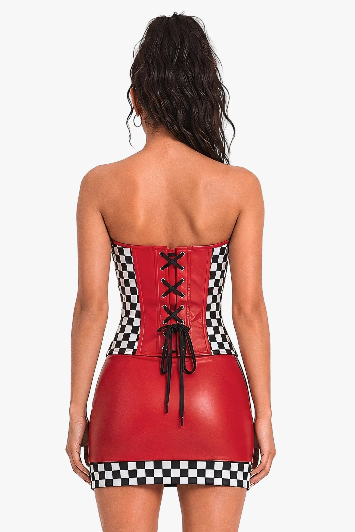 A woman viewed from the back wearing a strapless corset with black-and-white checkered side panels and a lace-up back, paired with tall black platform boots, against a plain light background.
