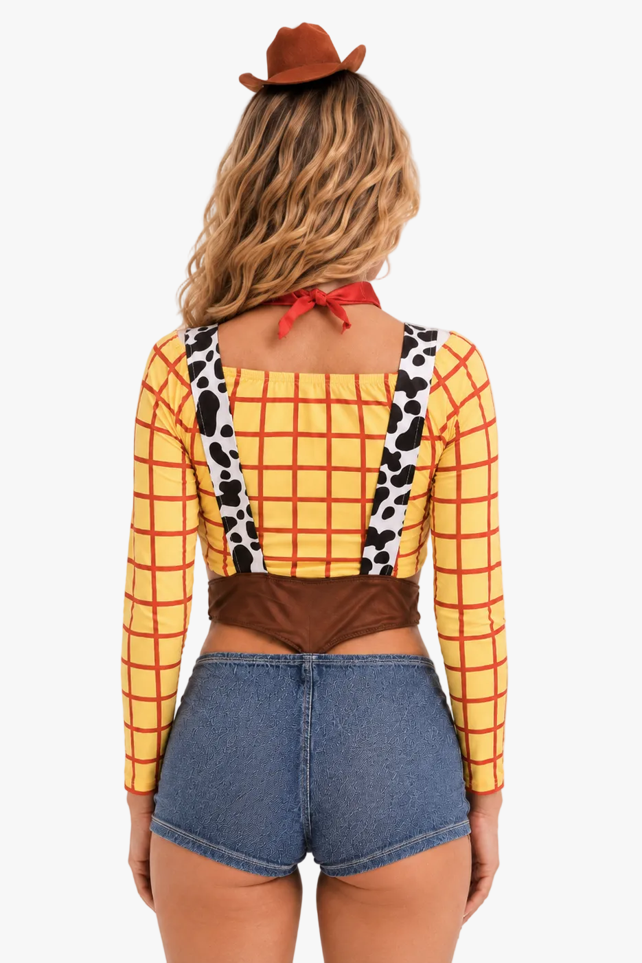 A woman shown from the back wearing a Woody-inspired costume top with a yellow and red plaid pattern, cow-print suspenders, a brown waistband, and a red neck tie, paired with denim shorts and a brown hat against a light gray studio background.