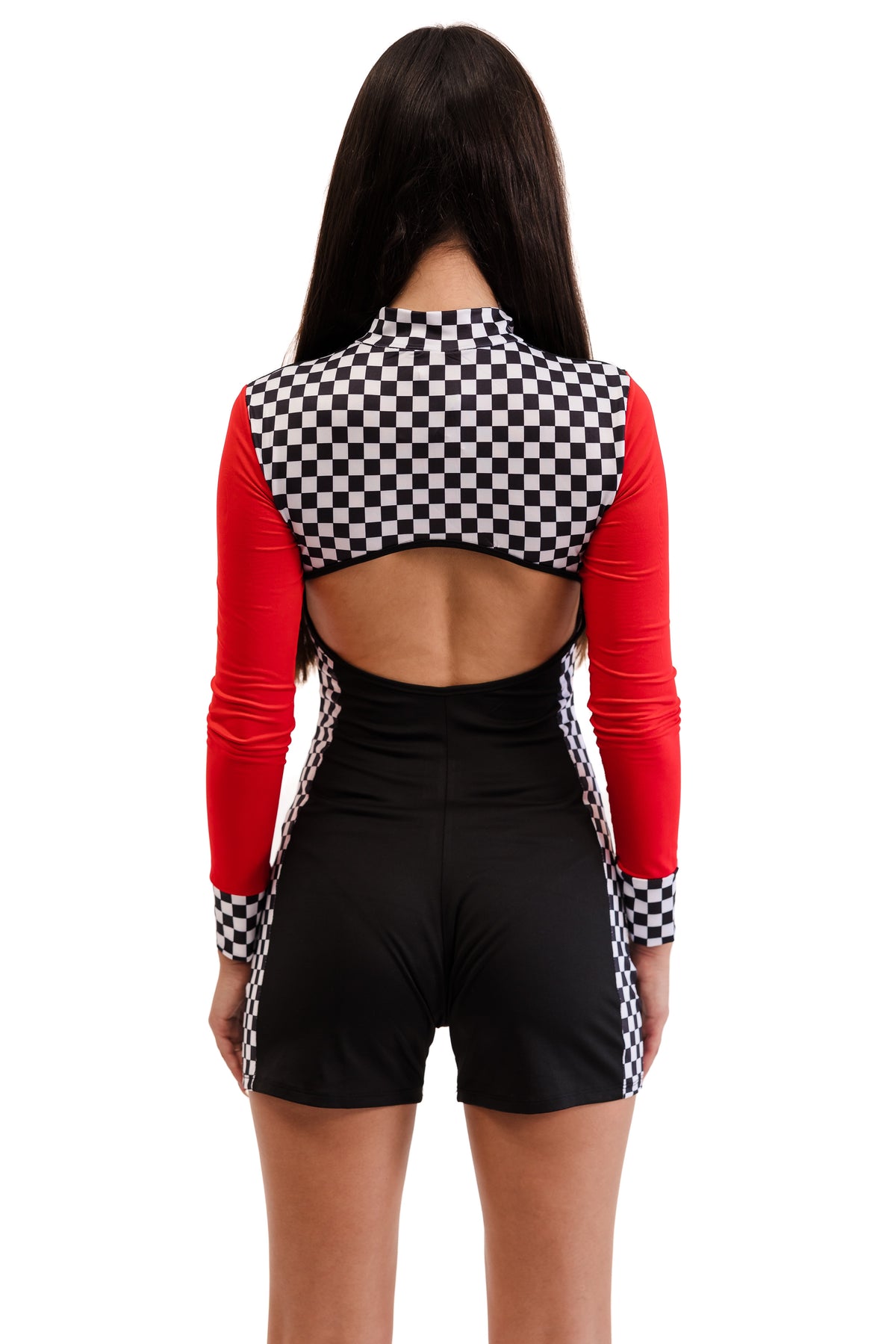 Person wearing a red and black checkered outfit with open back