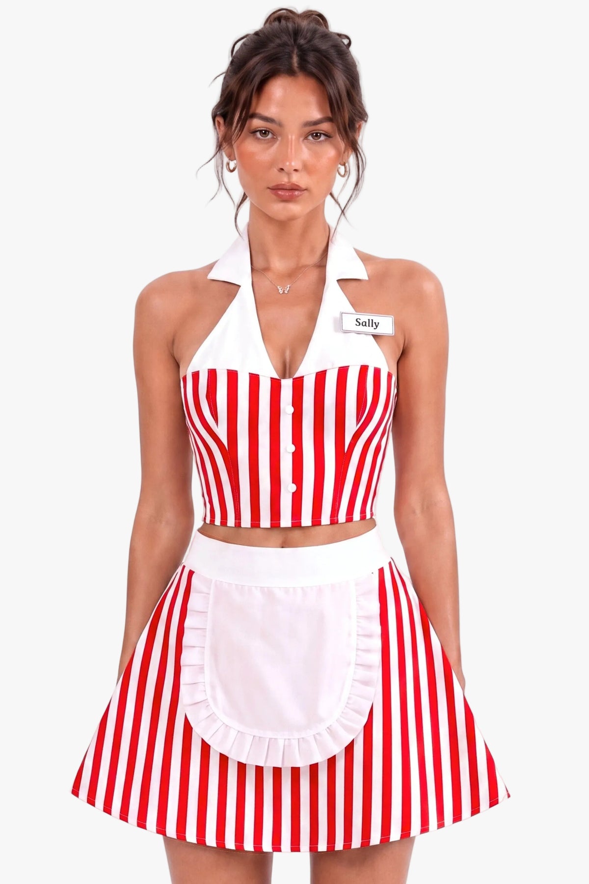 A woman modeling a red and white vertically striped diner costume set consisting of a halter crop corset top, matching skirt, and a white apron with a ruffled hem. She is wearing a name tag that says 'Sally' against a plain white background.