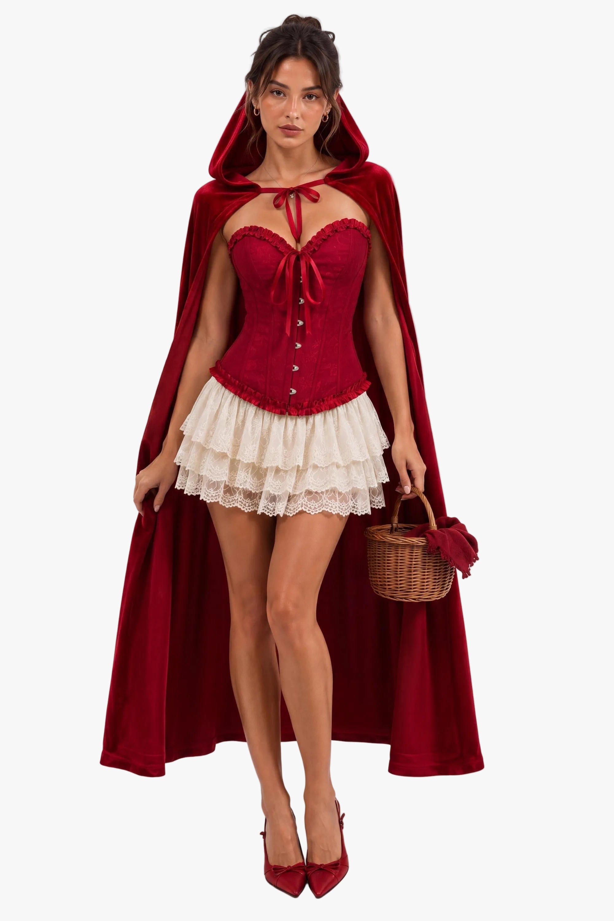 A model wearing a red hooded cape, a red corset-style top, a cream ruffled skirt, and red heels, holding a small wicker basket against a plain white studio background.