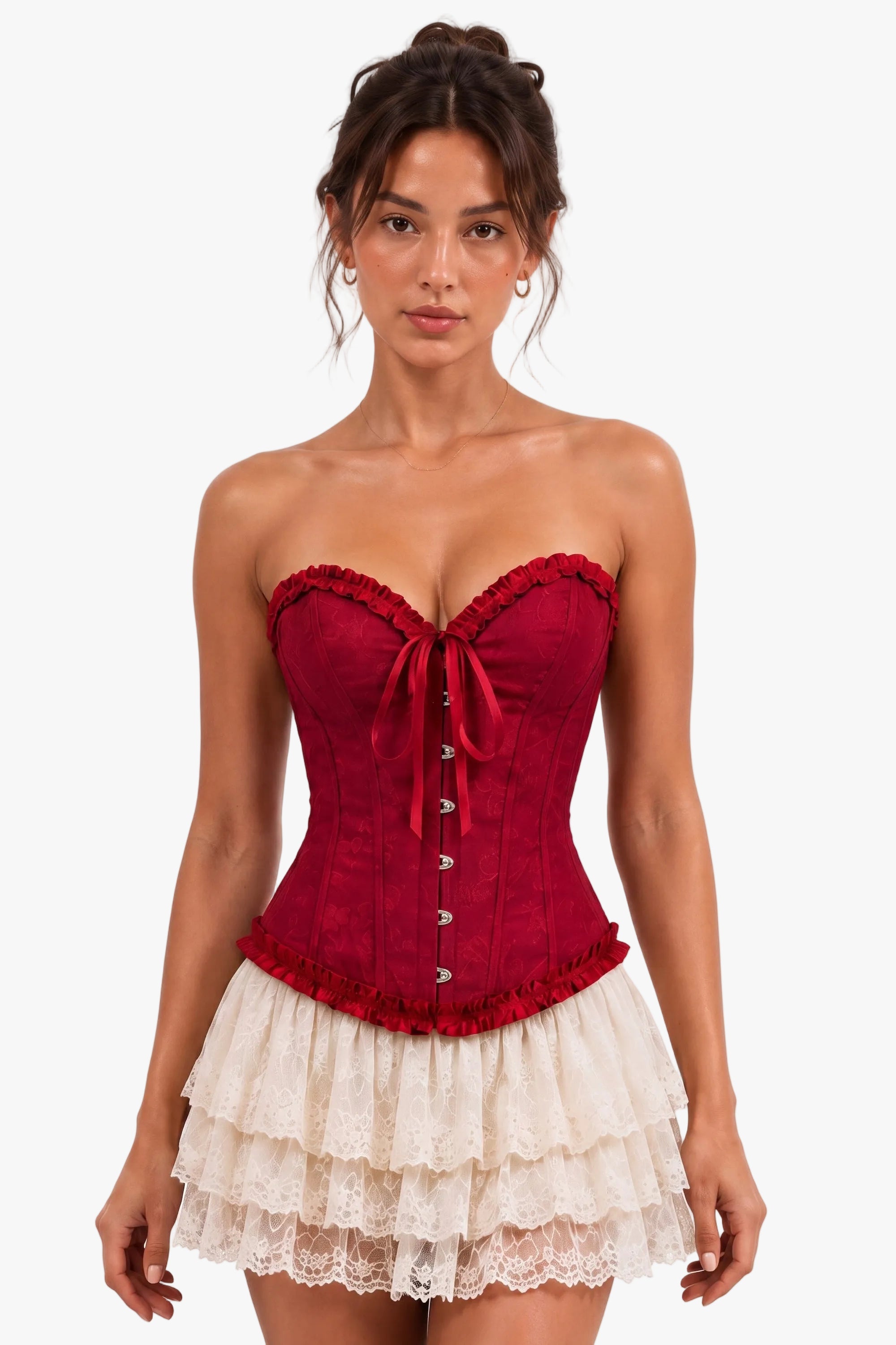 A woman modeling a strapless corset top in deep red with a matching red bow and lace trim, paired with a cream ruffled skirt, against a plain white studio background.