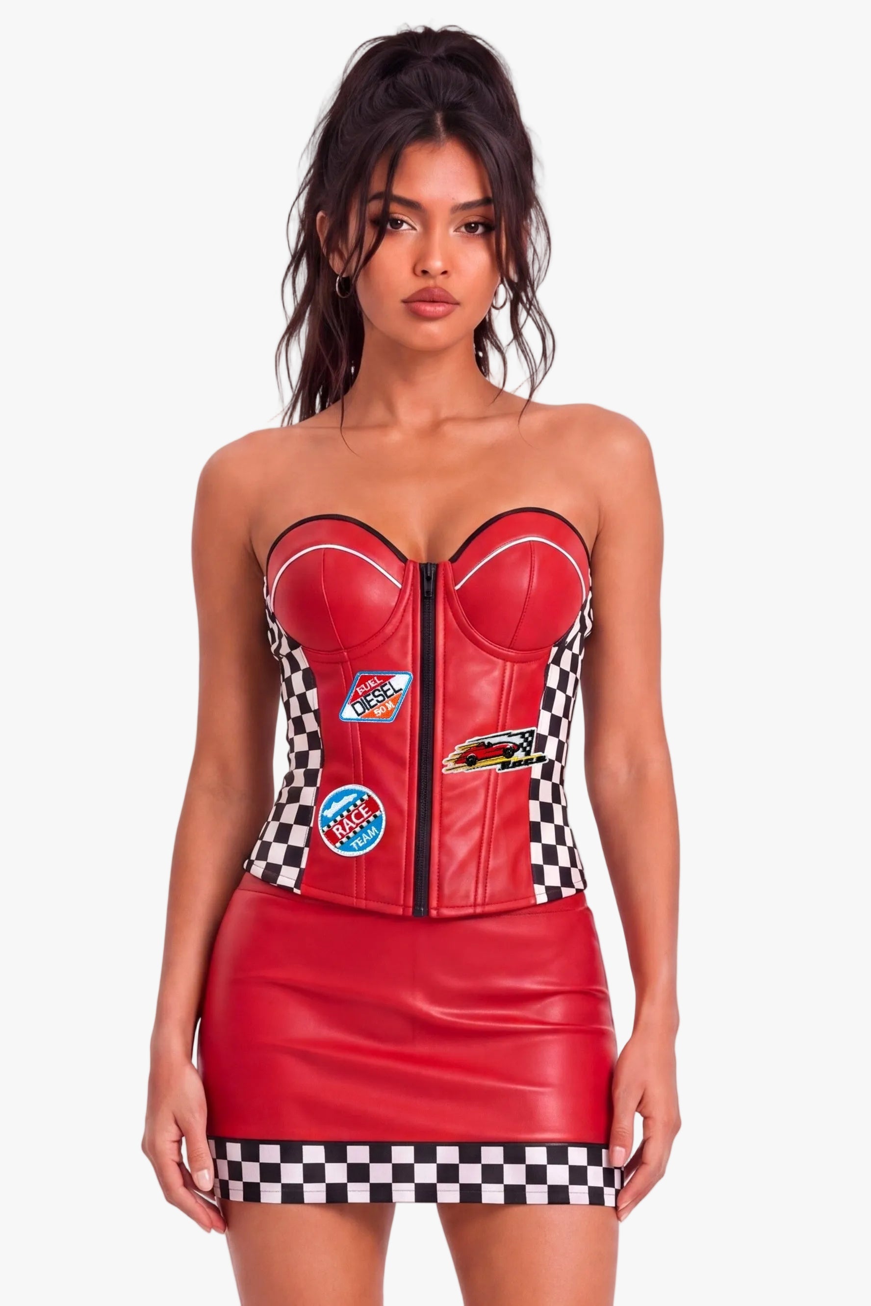 A model wearing a red strapless faux leather corset with a black-and-white checkered waistband and side panels, decorated with small racing patches, paired with matching mini skirt. 